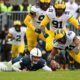 Michigan football looks to recover a Penn State fumble. James Franklin and Kalen King.