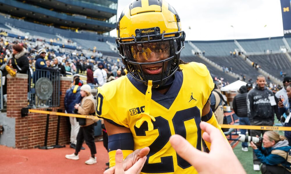 Maize Team defensive back Jyaire Hill (20) shakes hands with fans before the spring game at Michigan Stadium in Ann Arbor on Saturday, April 20, 2024.