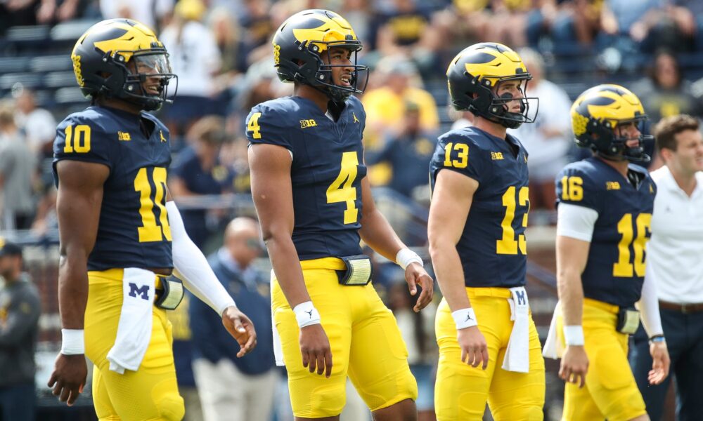 Michigan quarterbacks Alex Orji (10), Jayden Denegal (4), Jack Tuttle (13) and Davis Warren (16) practice before the UNLV game at Michigan Stadium in Ann Arbor on Saturday, Sept. 9, 2023.