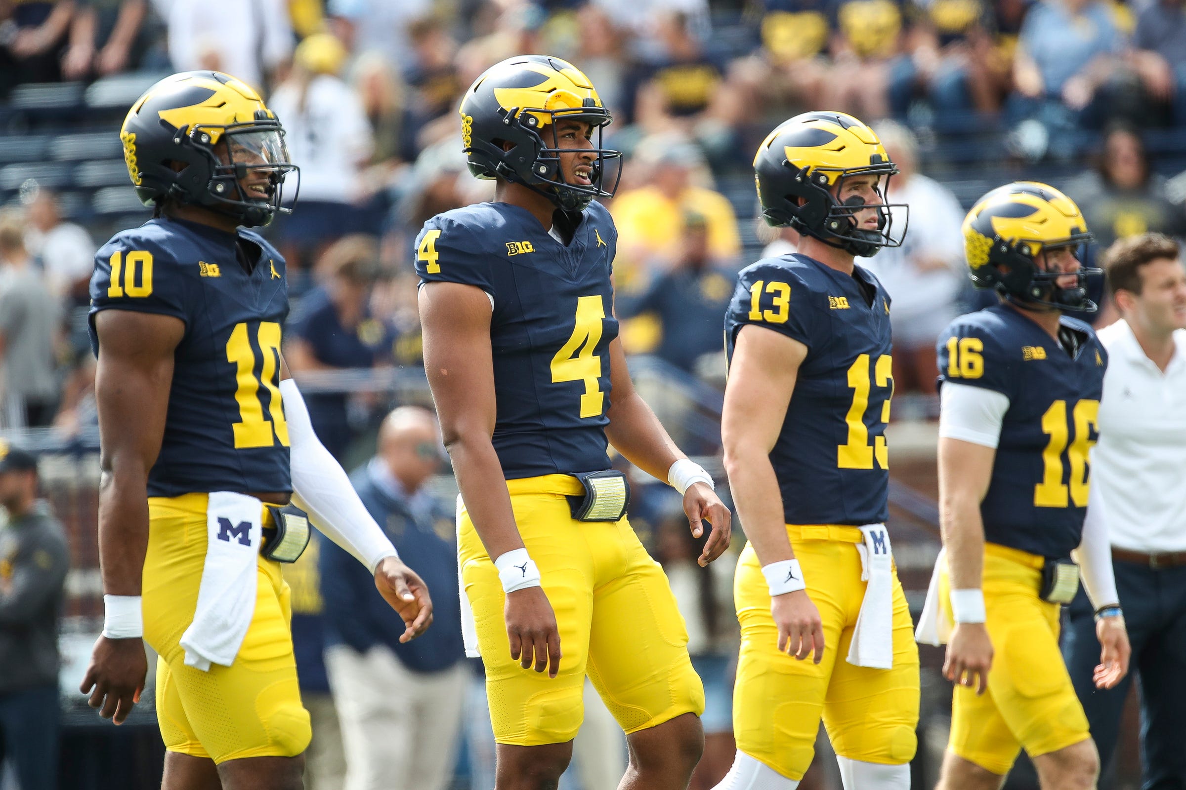 Michigan quarterbacks Alex Orji (10), Jayden Denegal (4), Jack Tuttle (13) and Davis Warren (16) practice before the UNLV game at Michigan Stadium in Ann Arbor on Saturday, Sept. 9, 2023.