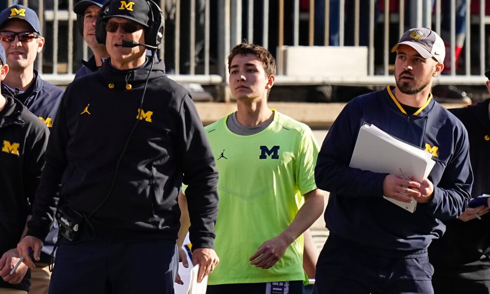 Michigan Wolverines head coach Jim Harbaugh watches from the sideline beside off-field analyst Connor Stalions, right, during a game against the Ohio State Buckeyes at Ohio Stadium in 2022.