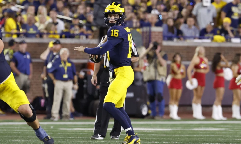 Davis Warren drops back for a pass in Michigan football vs fresno state