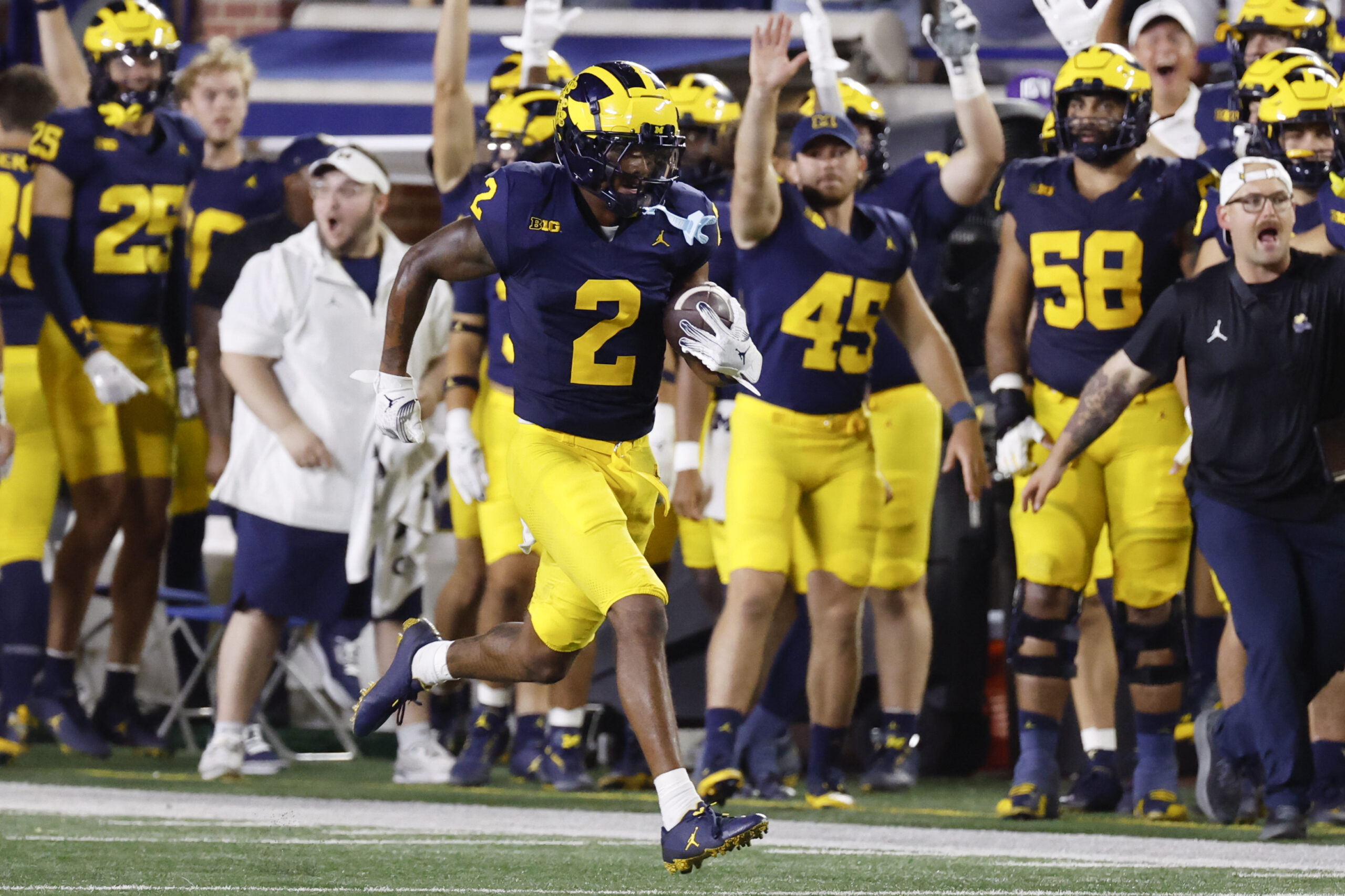 Aug 31, 2024; Ann Arbor, Michigan, USA; Michigan Wolverines defensive back Will Johnson (2) runs the ball after he makes an interception in the second half against the Fresno State Bulldogs at Michigan Stadium. Mandatory Credit: Rick Osentoski-USA TODAY Sports