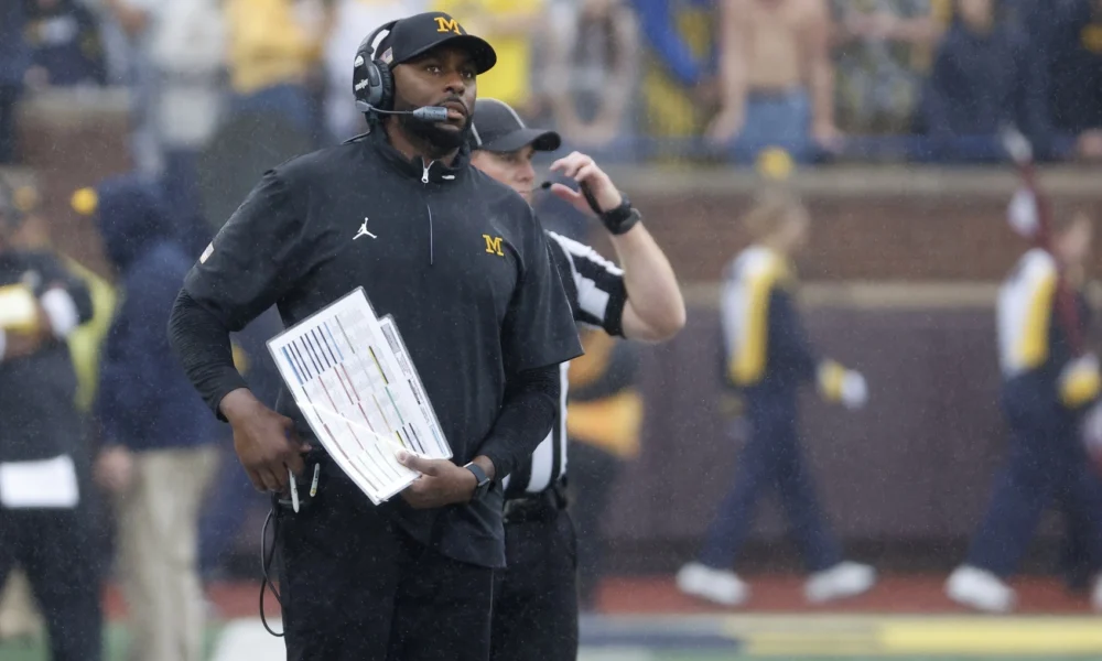 Michigan football head coach Sherrone Moore watches their game vs Minnesota