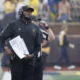 Michigan football head coach Sherrone Moore watches their game vs Minnesota