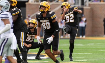 Luke Bauer watching the ball after he punts it away