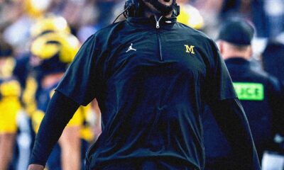Sherrone Moore cheering on the sidelines at the Big House