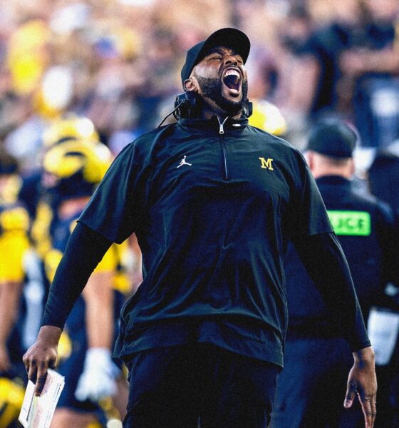 Sherrone Moore cheering on the sidelines at the Big House