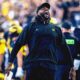 Sherrone Moore cheering on the sidelines at the Big House