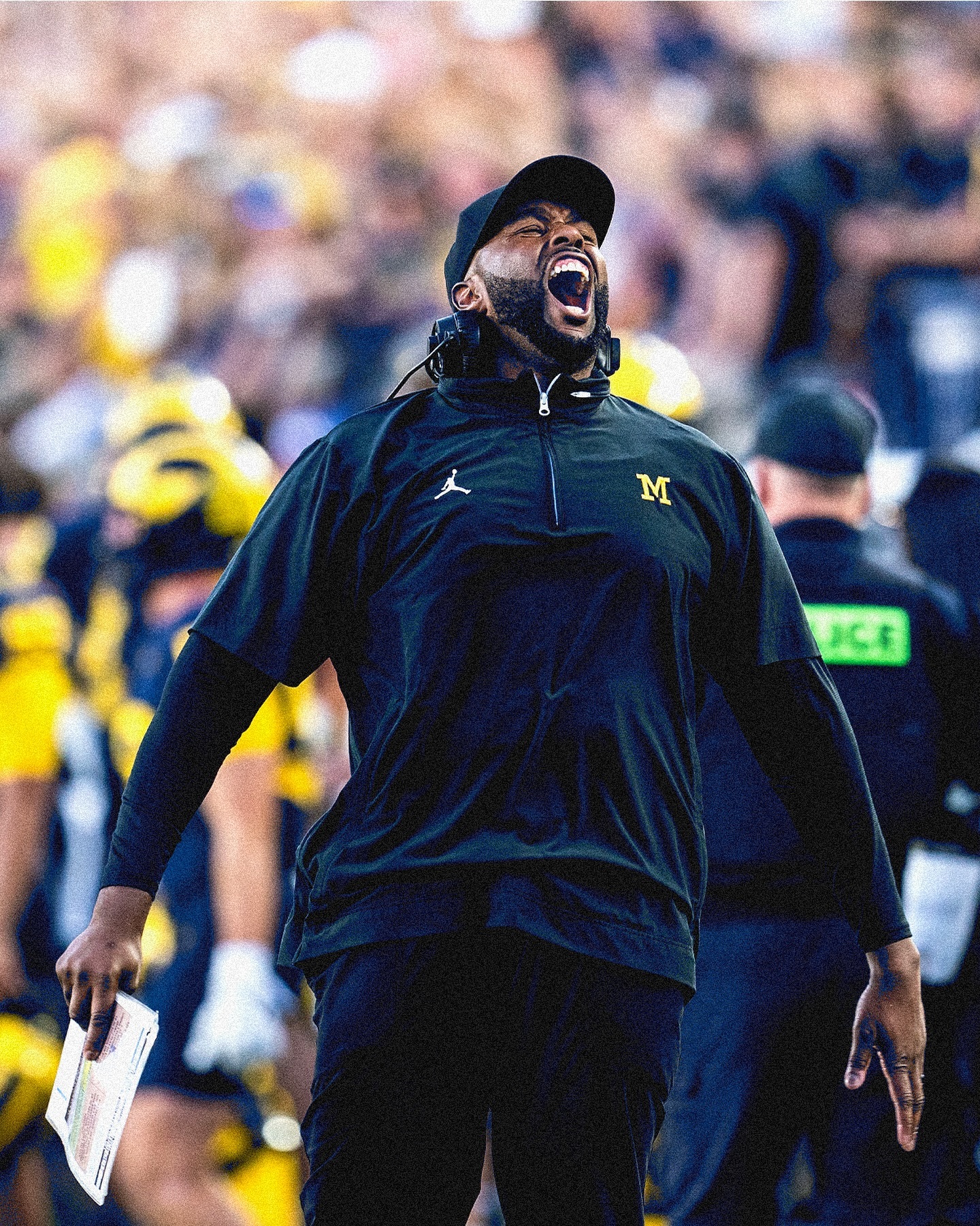 Sherrone Moore cheering on the sidelines at the Big House