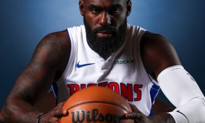 Tim Hardaway Jr. holding a basketball in a Detroit Pistons jersey