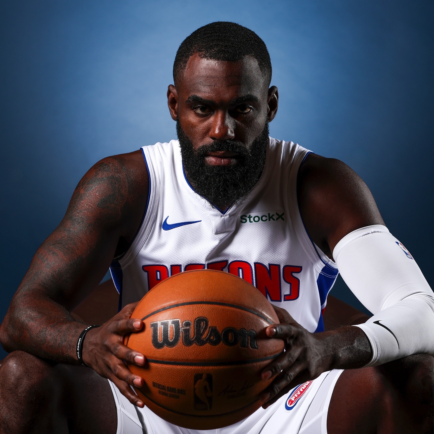 Tim Hardaway Jr. holding a basketball in a Detroit Pistons jersey