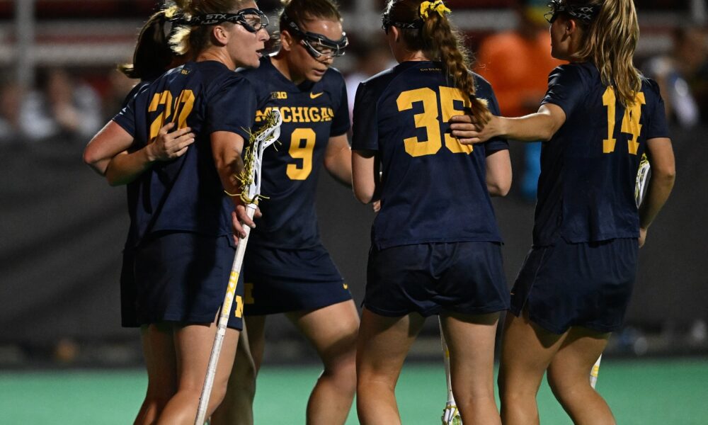 Michigan Women's Lacrosse squad huddled on the field