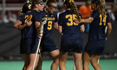 Michigan Women's Lacrosse squad huddled on the field