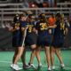 Michigan Women's Lacrosse squad huddled on the field