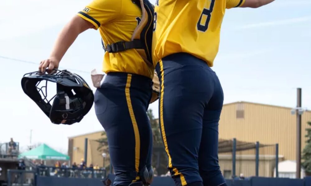 Pitchers Erin Hoehn and Lauren Derkowski celebrate their upset of top seed Oregon