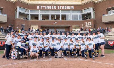 Michigan Softball team posing at Bittinger Stadium after their Big Ten tournament win