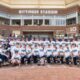Michigan Softball team posing at Bittinger Stadium after their Big Ten tournament win