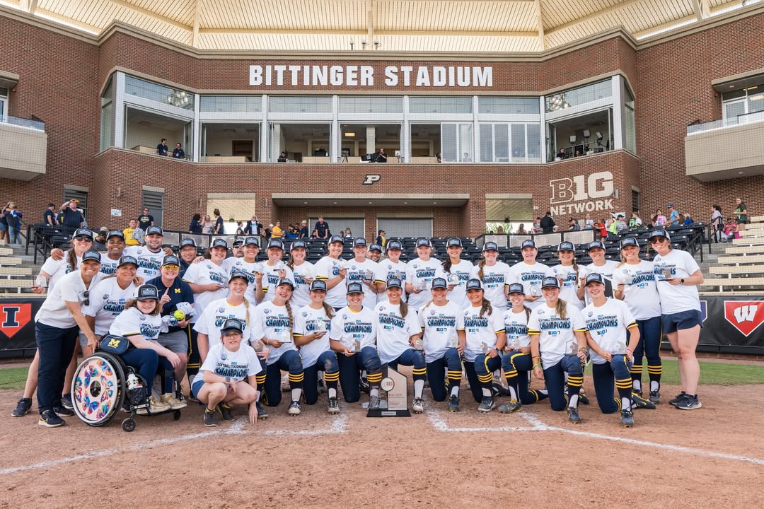 Michigan Softball team posing at Bittinger Stadium after their Big Ten tournament win