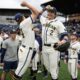Michigan baseball squad celebrating after winning their final game of the regular season